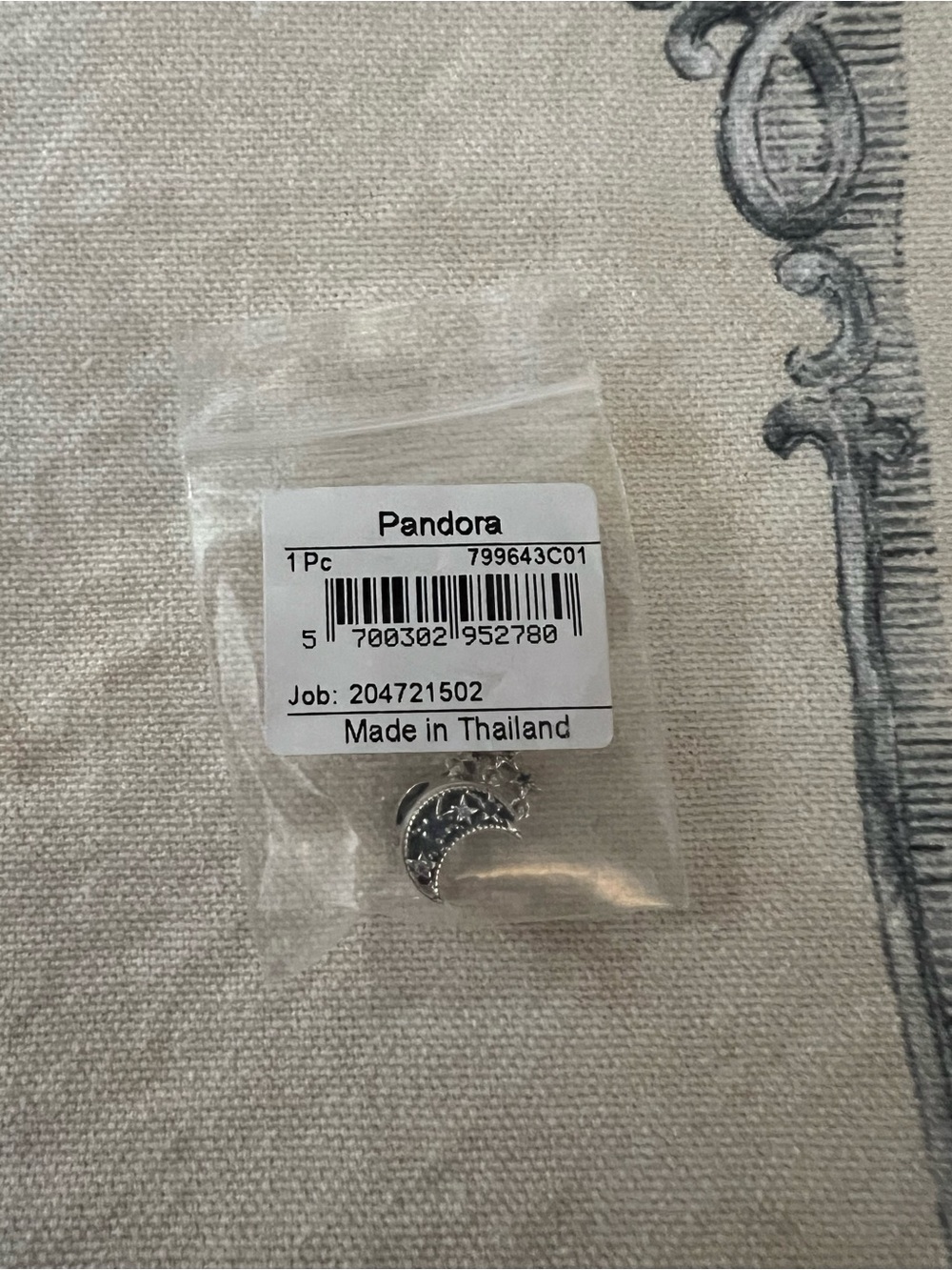 Charm in small bag
